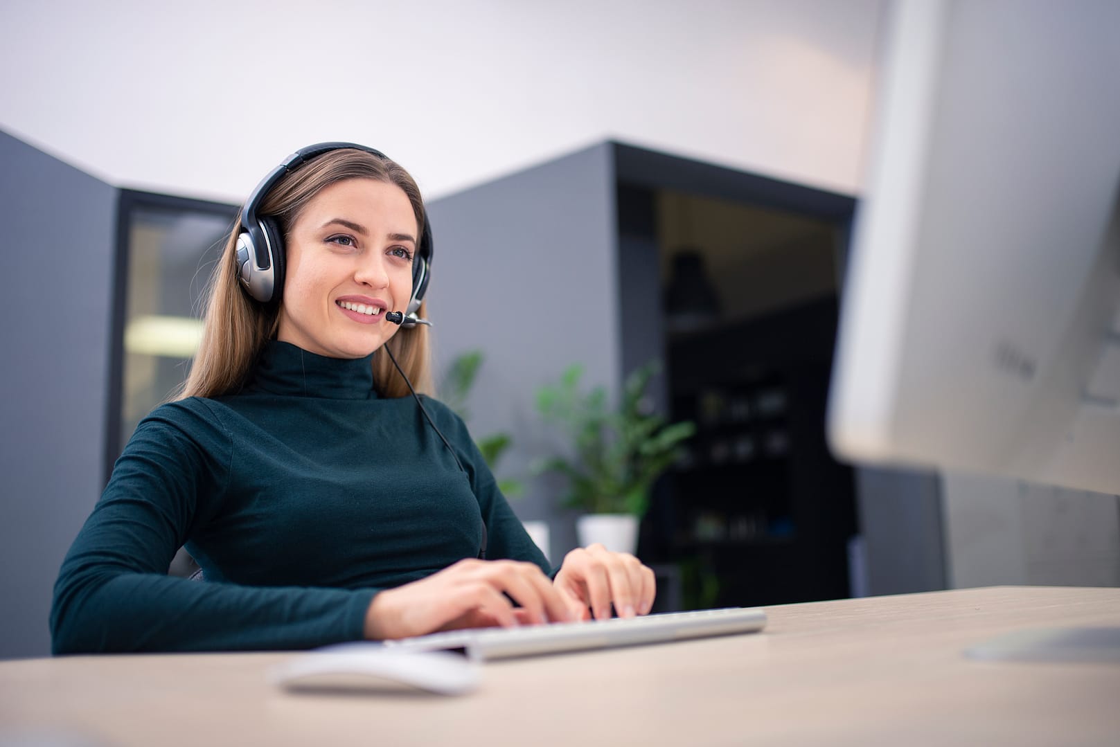 Young woman wearing headset while working at office